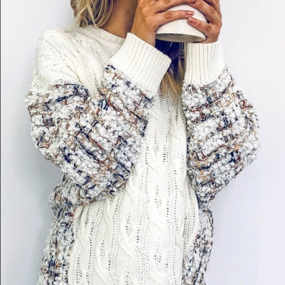 Knit sweater with metallic thread detail.